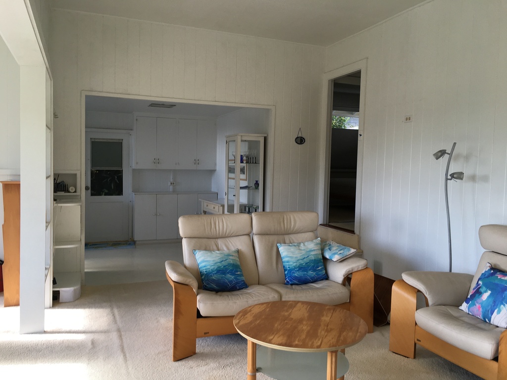 Living room with view into the kitchen area