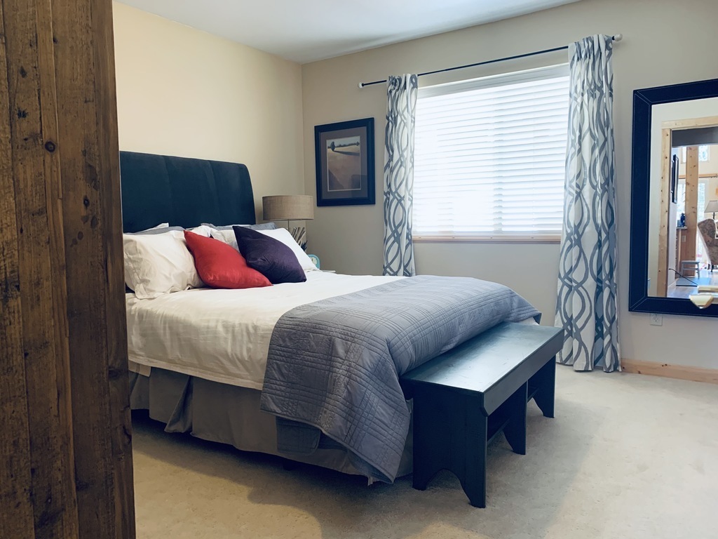 Downstairs bedroom with queen bed