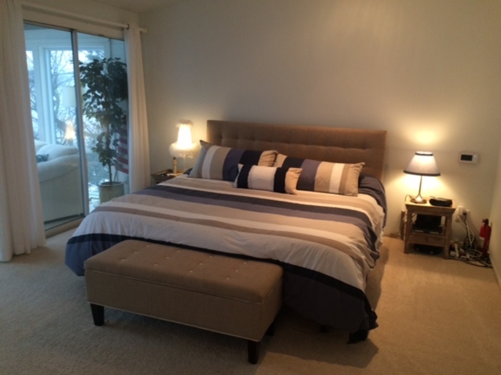 Master bedroom with balcony looking over the water