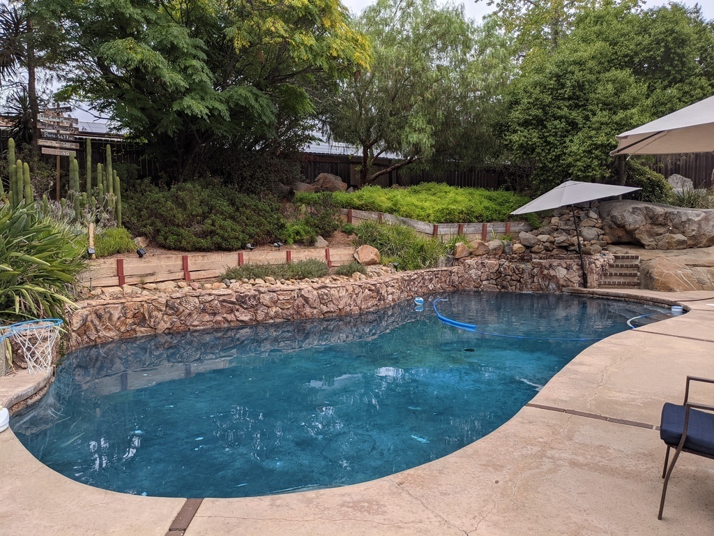 Pool and hot tub with waterfall. Built into a granite rock hillside. 