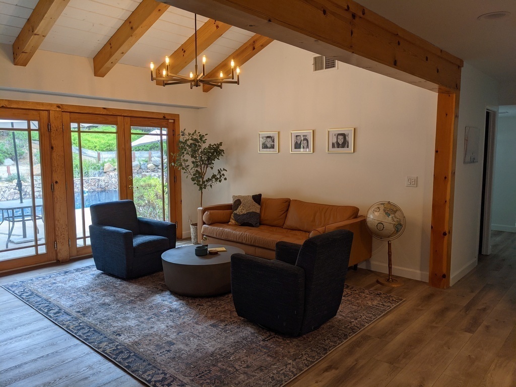 Second living space with pool views and gas fireplace.