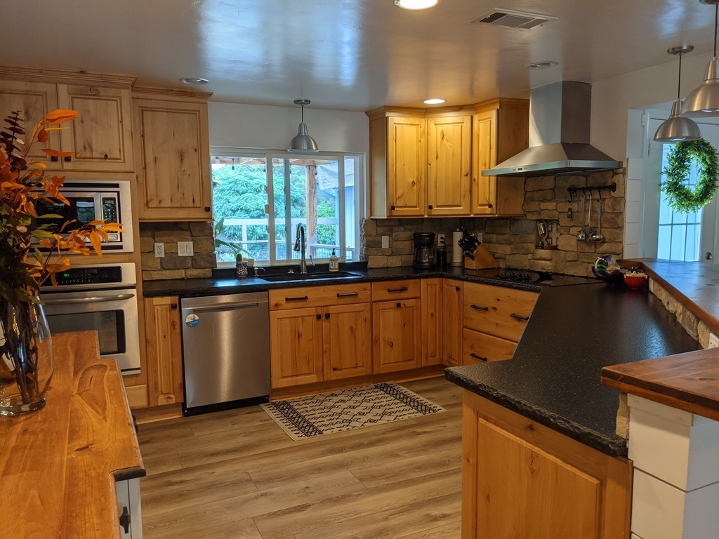 Kitchen is fully stocked as we love to cook and entertain! Views of deck and front fenced yard.