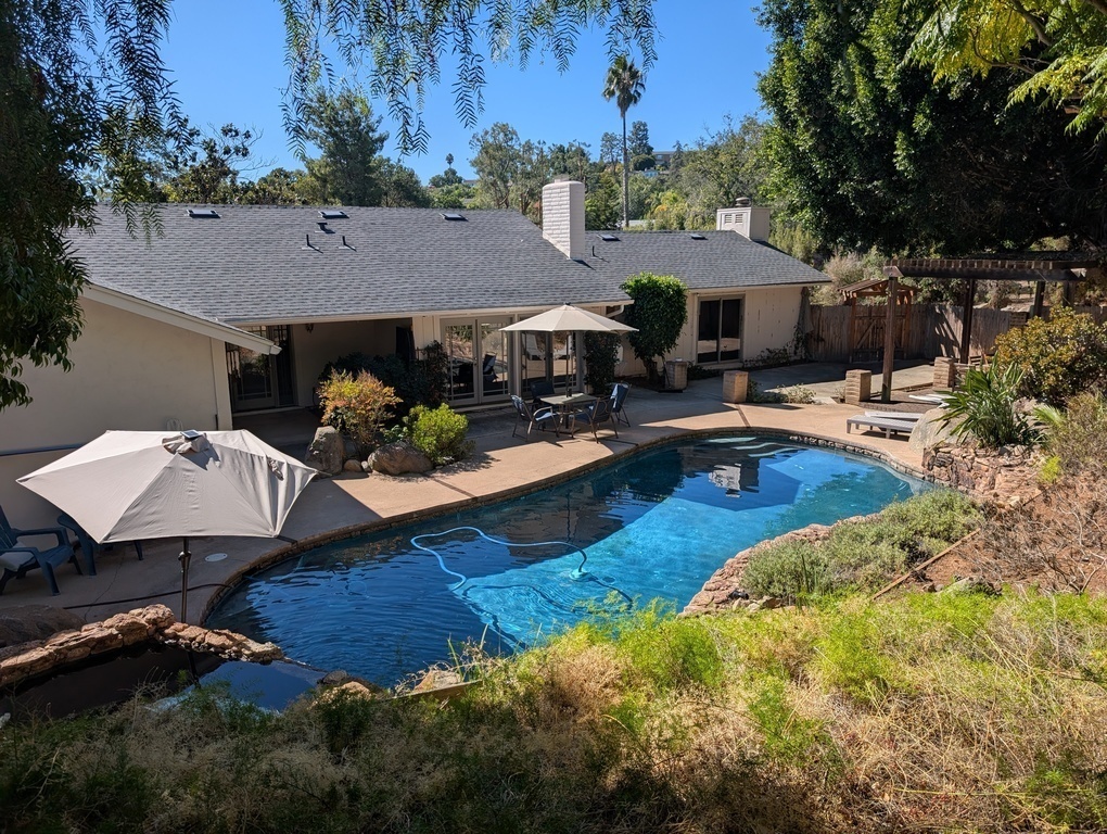 Pool yard with hot tub.