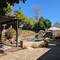 Backyard with view of pool. Two dining sets.