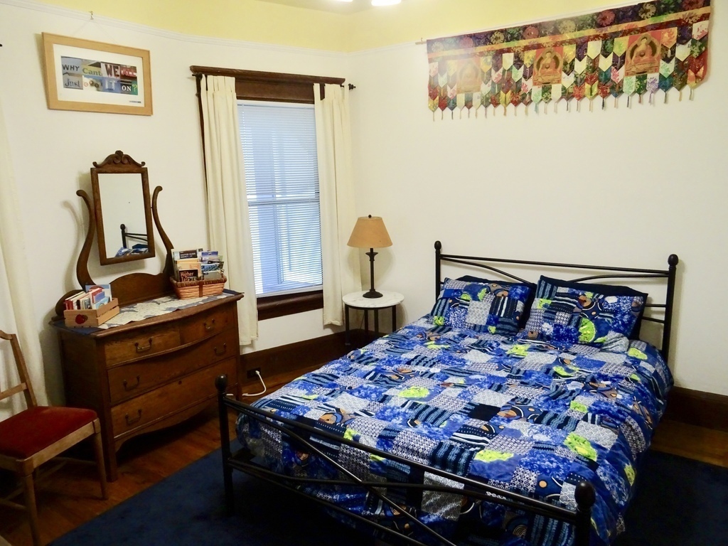 guest bedroom with queen bed for two people