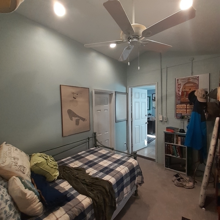 Small single bed off of sunroom