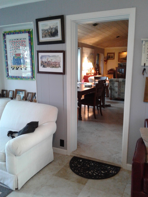 From the sunroom, enter the Main living area: Dining and kitchen with views to the beautiful river beyond.