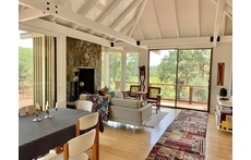 The great room of the house combines Living, Dining, and Kitchen areas, with wonderful views 