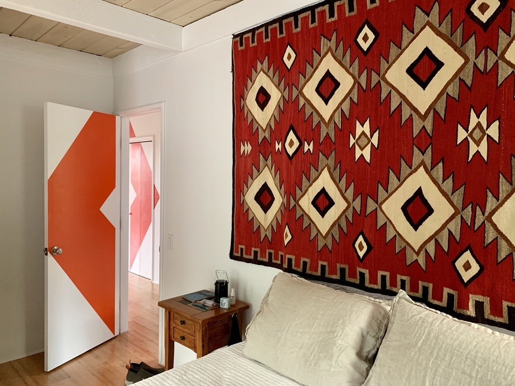 Main bedroom with door to hallway mural