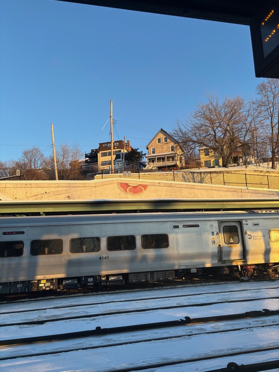The train to New York City runs across the street from our house. Our house is the stucco one in the photo. 