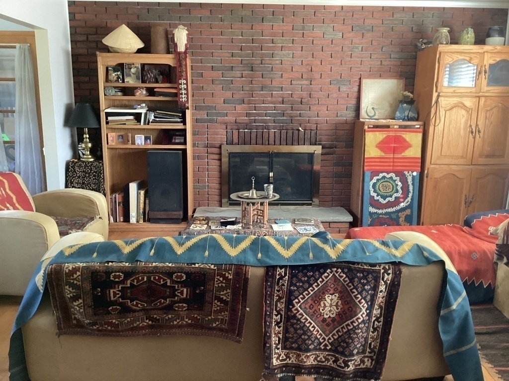 Living room with fireplace and ethnic textiles.