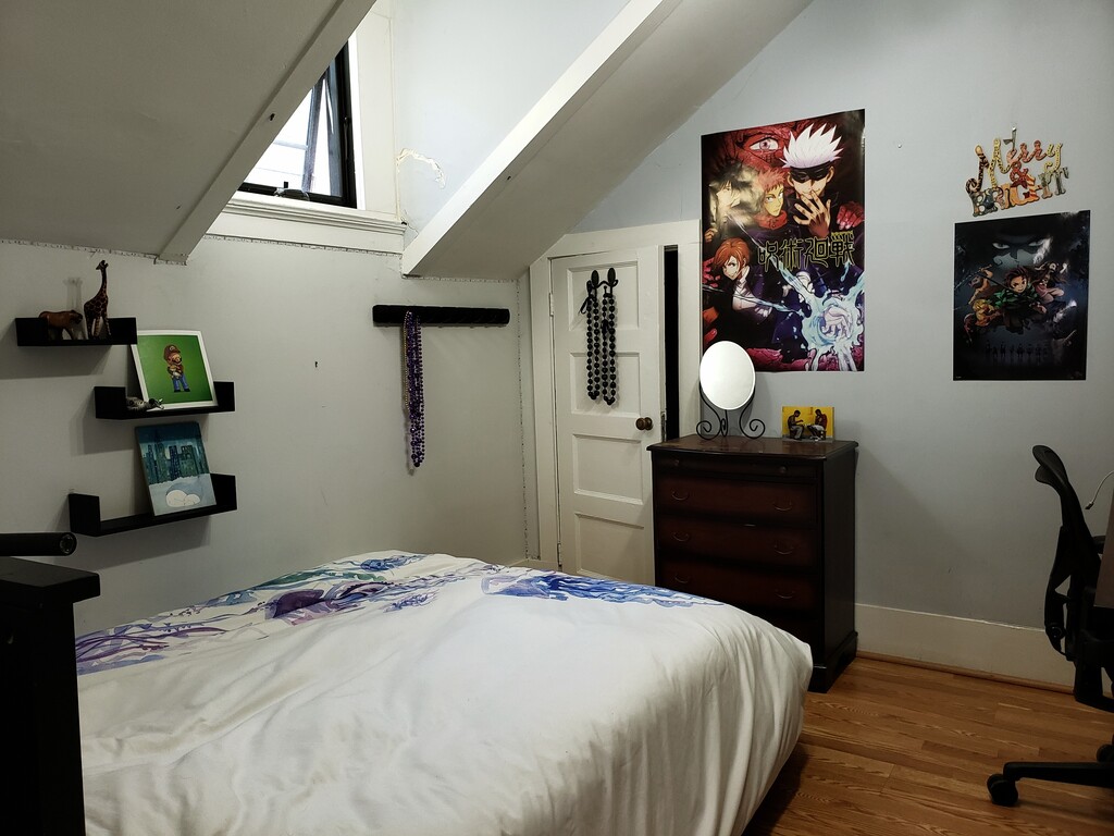 upper bedroom with full size bed with window (side facing)