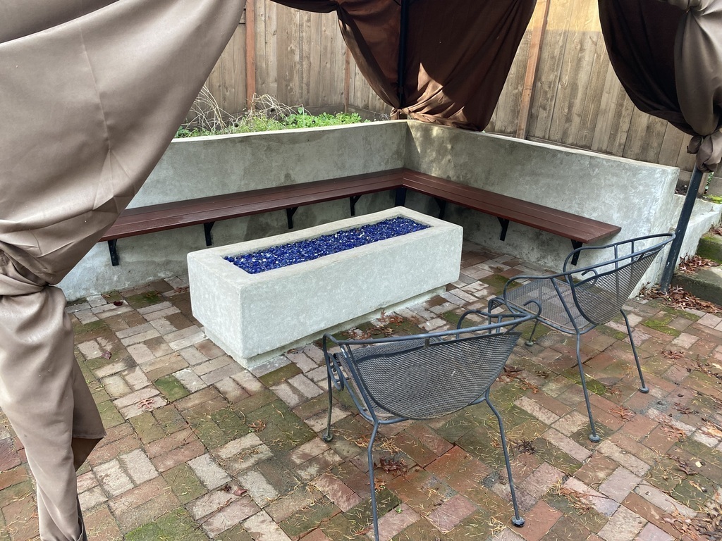 The gas-fed fire feature, next to the propane grill for outdoor cooking