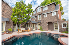 Pool and outdoor seating in fenced yard