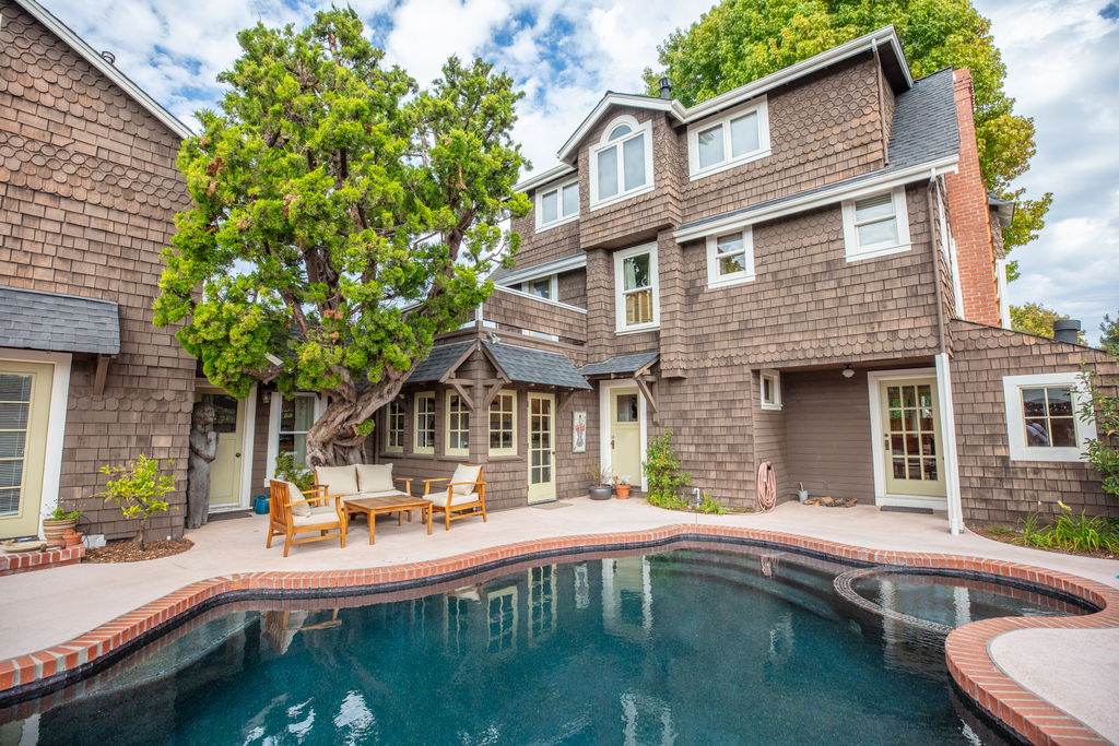 Pool and outdoor seating in fenced yard