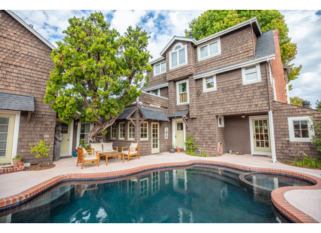 Pool and outdoor seating in fenced yard