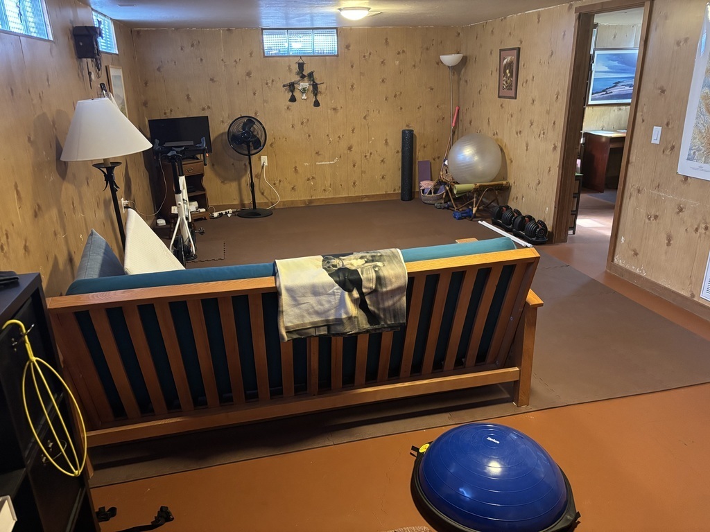 Basement workout area with futon for overflow guests