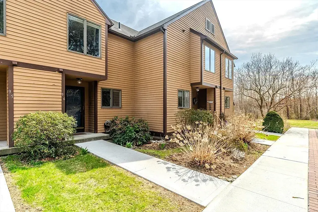 Front walkway into the unit with a space for cars right in front