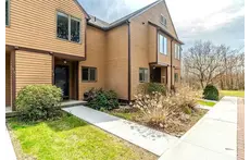 Front walkway into the unit with a space for cars right in front