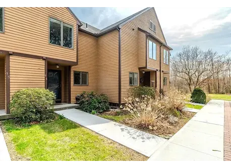 Front walkway into the unit with a space for cars right in front