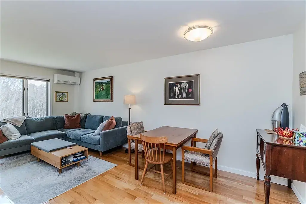 Living room with big windows facing the beautful meadow in the back and combined dining area