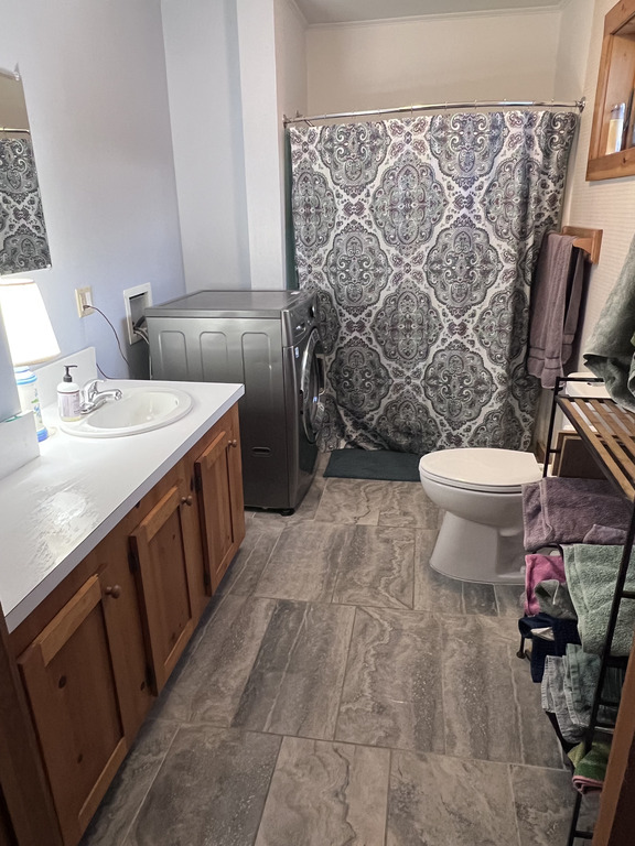 Downstairs Bathroom- Has shower/bath, sink, toilet and washing machine.  