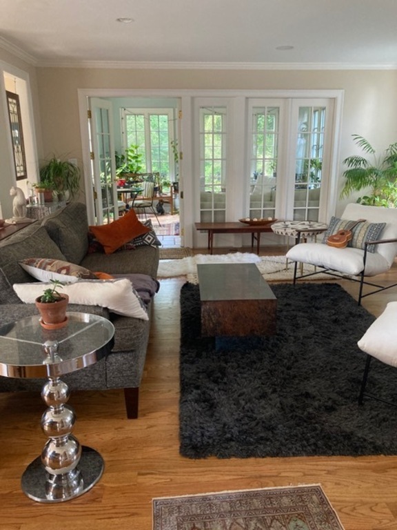 Living Room with Sunroom in Background