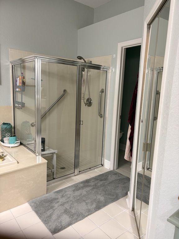 Walk in shower and closet toilet,  both have safety bars to prevent falls.