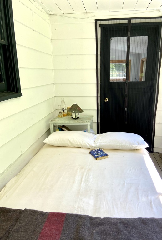 During the summer we like to sleep outdoors on this futon bed on the back porch which is under a roof in case it rains. 