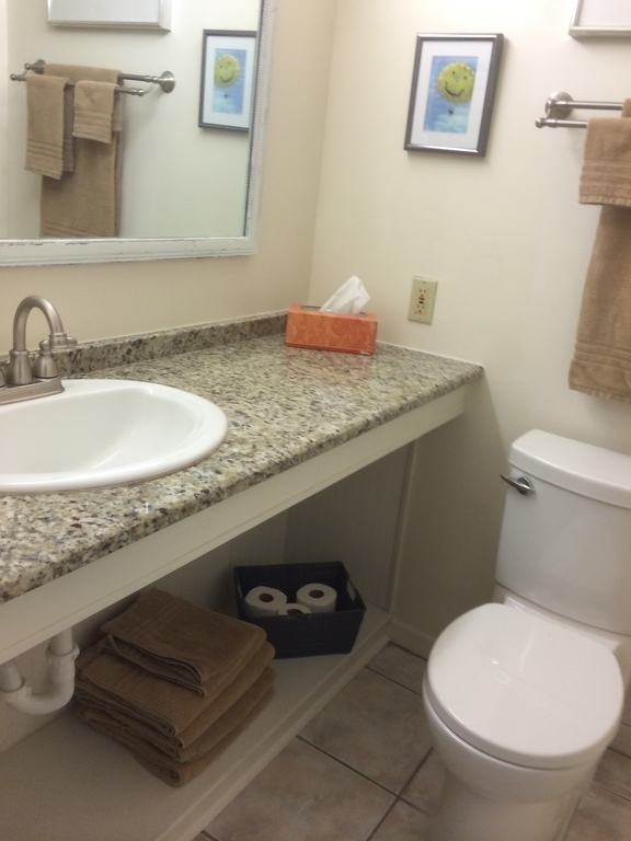 Ensuite bathroom for queen bed bedroom. Tub with shower behind door.