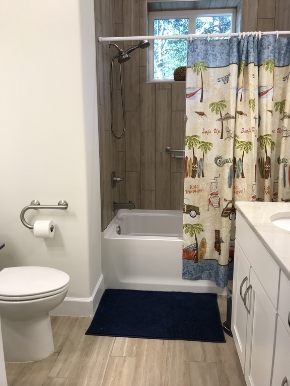 Bathroom downstairs with bathtub and two sinks
