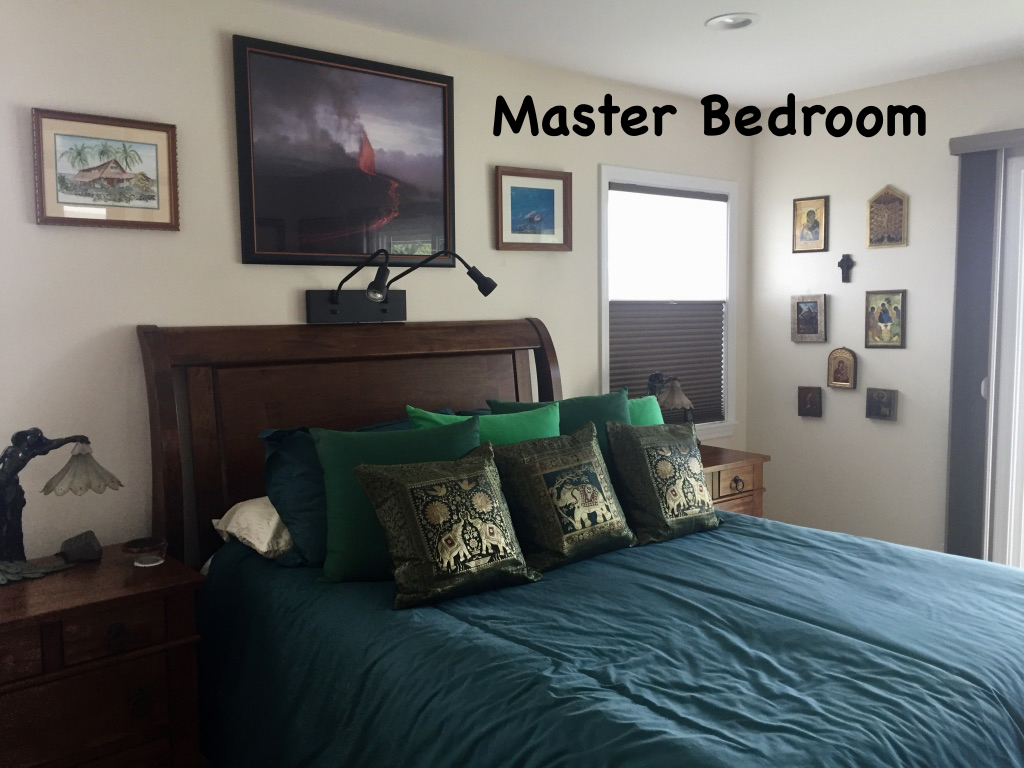 The large master bedroom is comfortable and has access to the pool