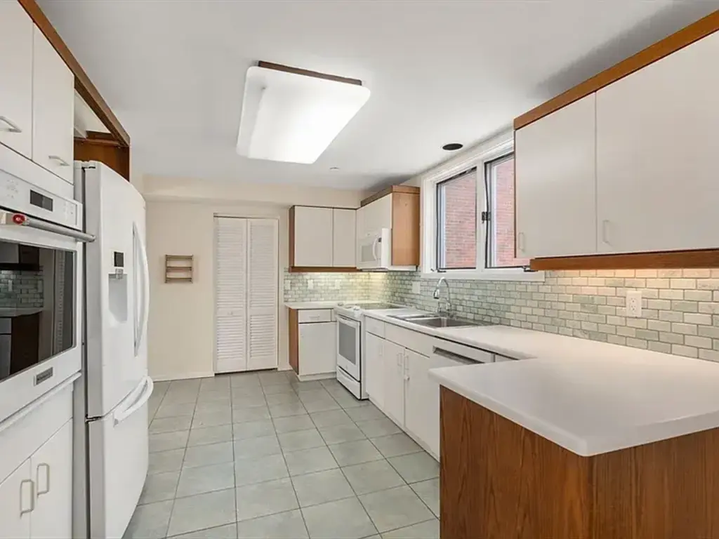 Kitchen. Closet at the end of kitchen has washer and dryer