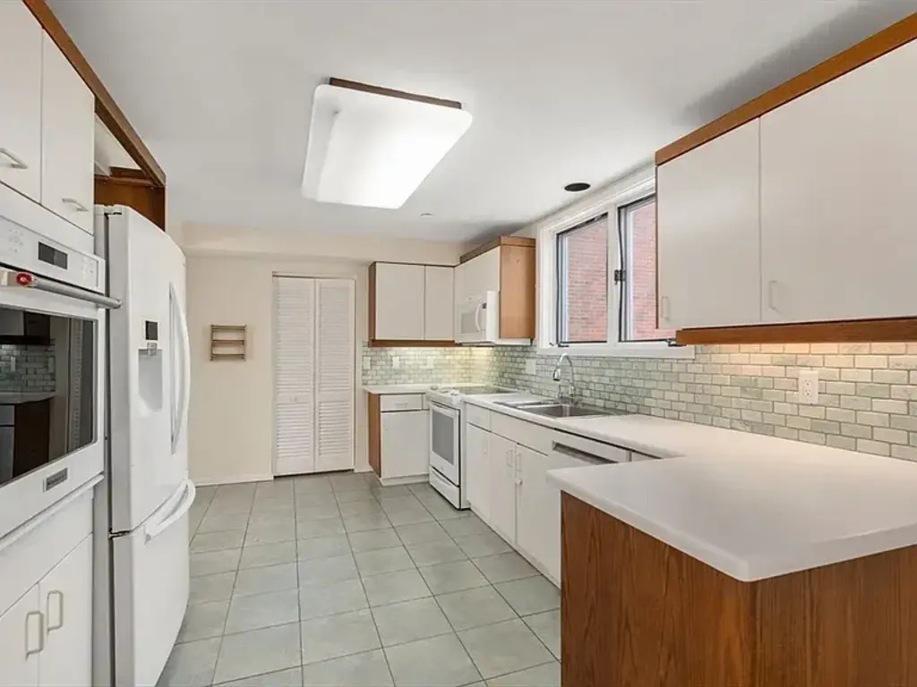 Kitchen. Closet at the end of kitchen has washer and dryer