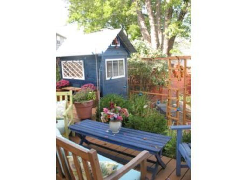 Part of the back garden and deck in Summer