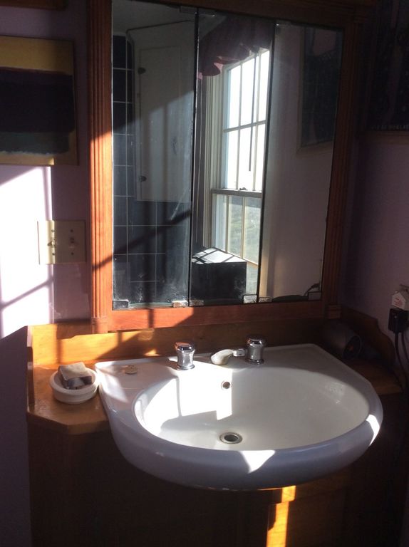 Bathroom sink in wooden cabinet