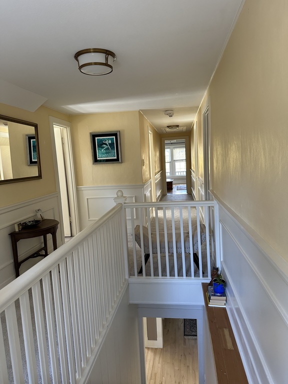 Upstairs hallway with bathroom and bedroom on the left, master bedroom straight ahead, and bedroom on the right.