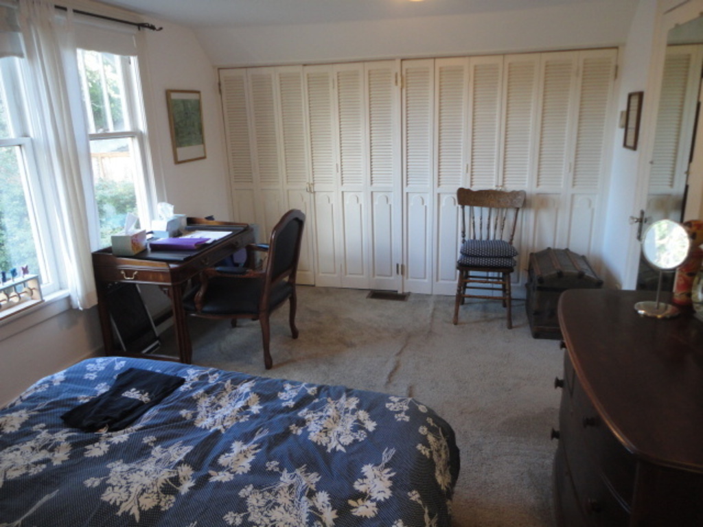 The bedroom has a desk and closet space