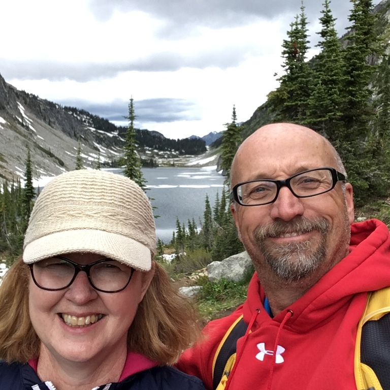 Theresa and Alan hiking in the mountains in June. At high elevations you will encounter some snow.
