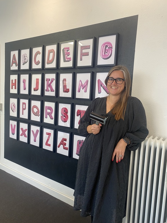 Pernille at one of her exhibitions in Copenhagen - here showing her linocut alphabet