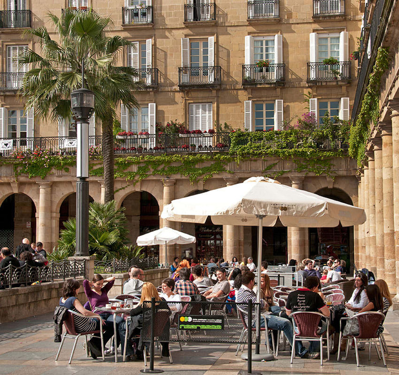 You can visit Plaza Nueva (10' by metro) and try some of the best pintxos ("Basque tapas") of the city.