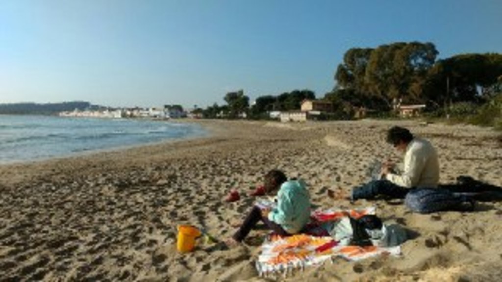 Reading on the beach in winter (when our daughter was 10)