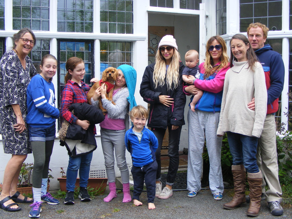 Extended family in front of house