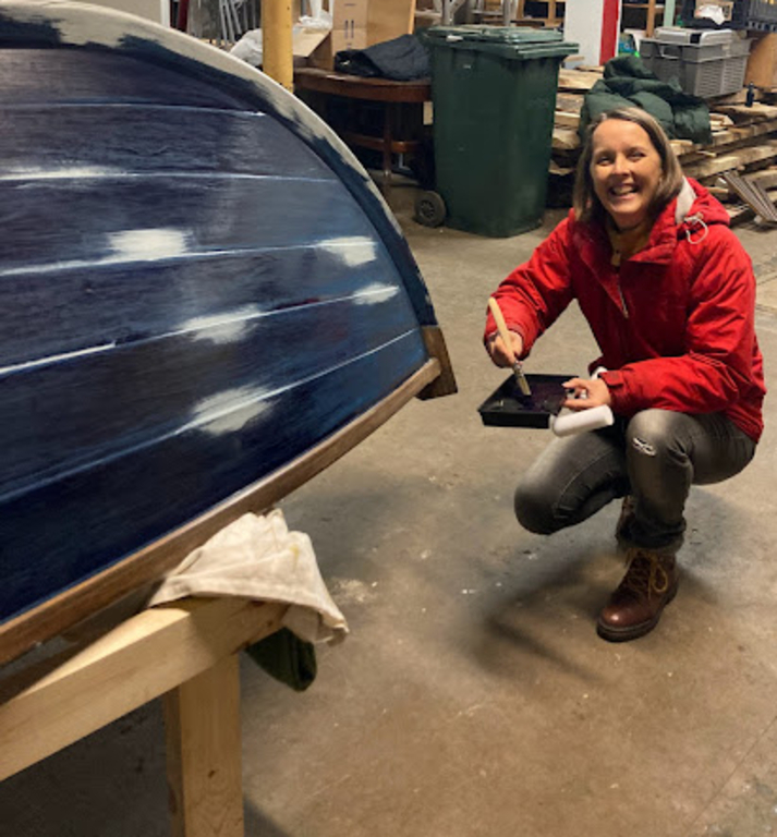 Kate doing maintenance on one of her clubs boats