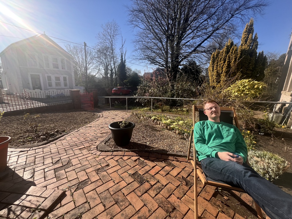 Paul in the sun enjoying our front garden.