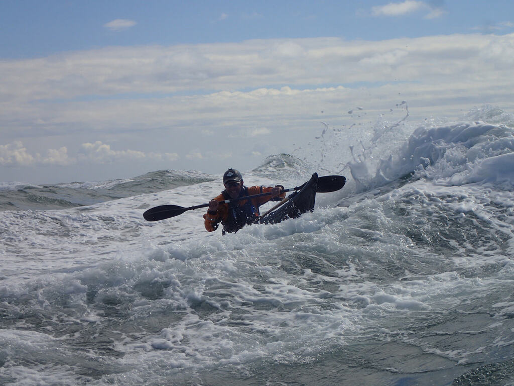 Eymi kayaking rough waters.