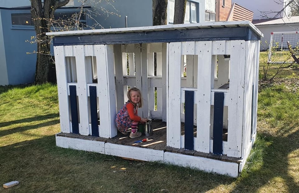 Matthildur in the playhouse in our garden