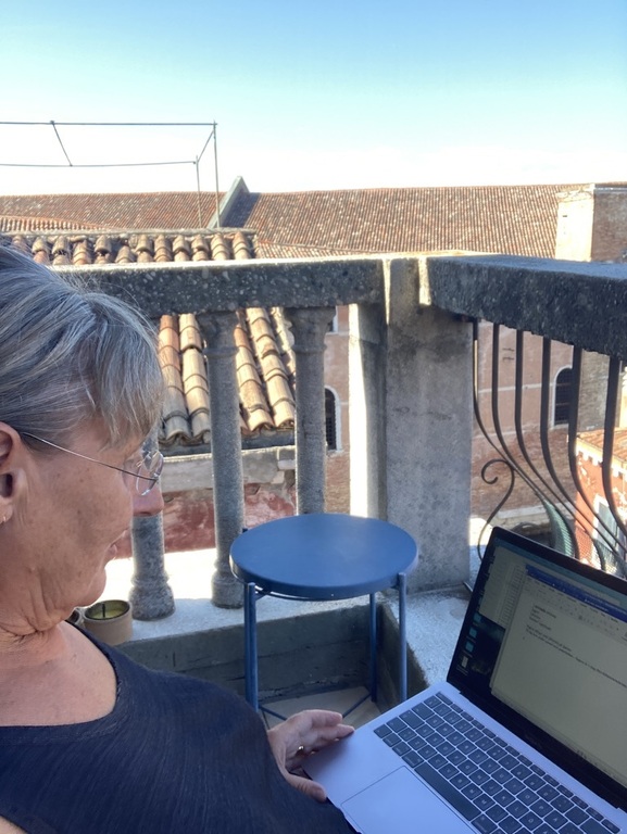 Marie writing on a balcony in Venice