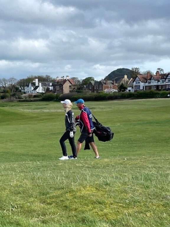 Playing golf at North Berwick, Scotland with caddie.