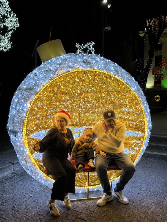 Family posing for pictures at Prescott Town Square, Christmas time. 